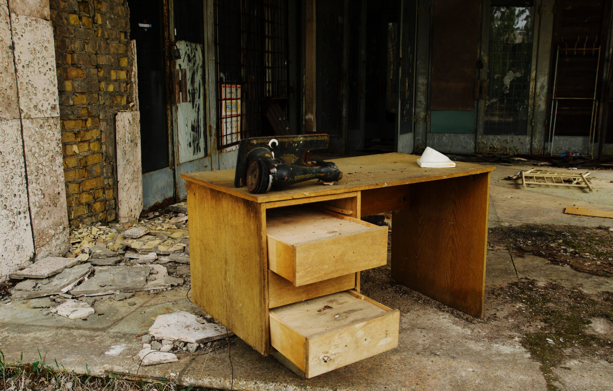 Old table with sewing machine at Chernobyl ghost town, Ukraine.