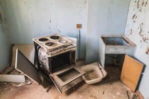 Interior view of a kitchen equipped with a stove, oven, and sink, highlighting essential cooking and food preparation areas.