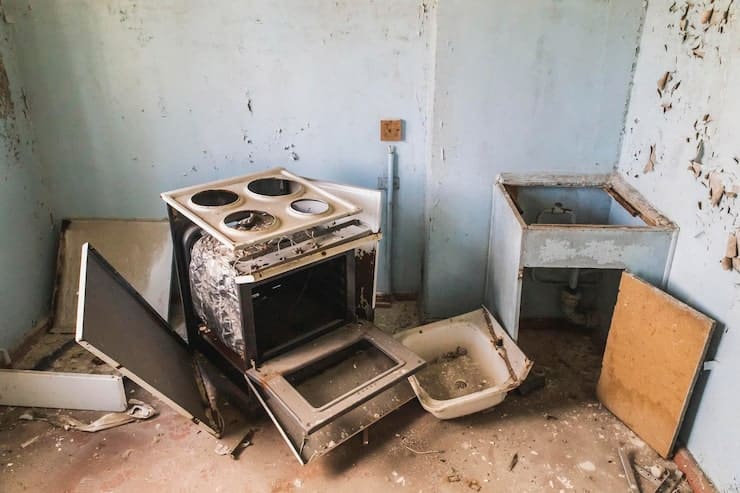 Interior view of a kitchen equipped with a stove, oven, and sink, highlighting essential cooking and food preparation areas.